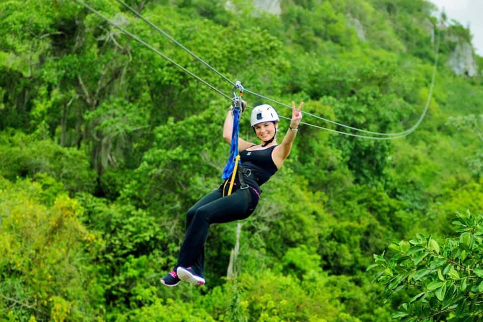 Punta Cana: Zip Line Adventure with Hotel Pickup - The suspension bridge moment over palm trees and rolling hills